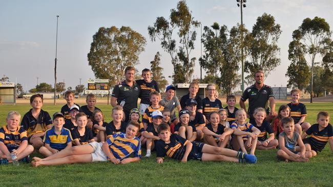 Dalby Wheatmen juniors meet Queensland Reds players Harry Hoopert (back left) and Hamish Stewart (back right) during the Reds-to-Regions tour. Photo: Emily Bradfield