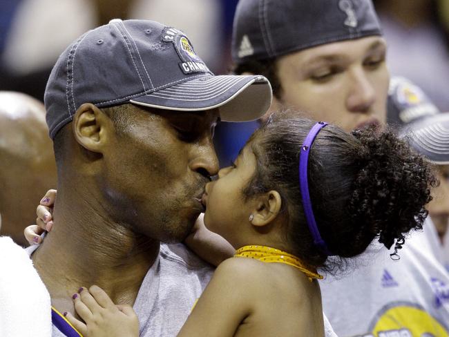 Los Angeles Lakers' Kobe Bryant kisses his daughter, Gianna in 2009. Picture: AP