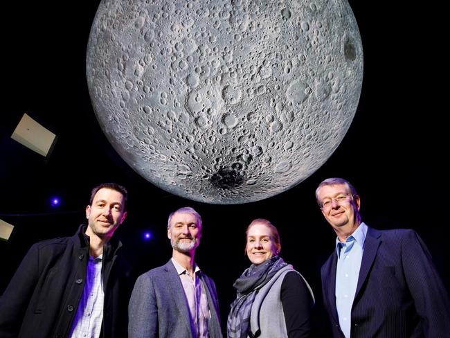 Geoscience Australia's Steve Petkovski, National Museum of Australia's Robert Bunzli, Questacon's Stephanie Hodge and CSIRO’s Dr Ed Kruzins, under the giant moon installation at Questacon. Photo: National Museum of Australia, Jason McCarthy.