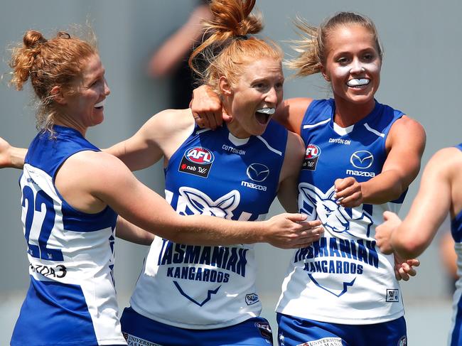 HOBART, AUSTRALIA - FEBRUARY 03: L-R Georgia Nanscawen, Alison Drennan, Kaitlyn Ashmore and Daisy Bateman of the Kangaroos celebrate during the 2019 NAB AFLW Round 01 match between the North Melbourne Tasmanian Kangaroos and the Carlton Blues at North Hobart Oval on February 03, 2019 in Hobart, Australia. (Photo by Adam Trafford/AFL Media/Getty Images)