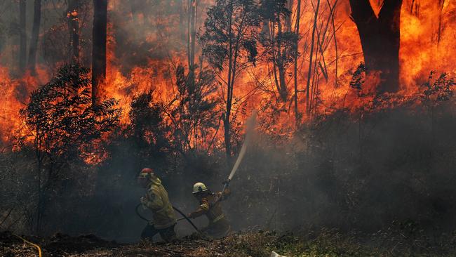 A RFS fire crews working to save properties on Ivatt St, Cobar Park near Lithgow. Picture: Tim Hunter