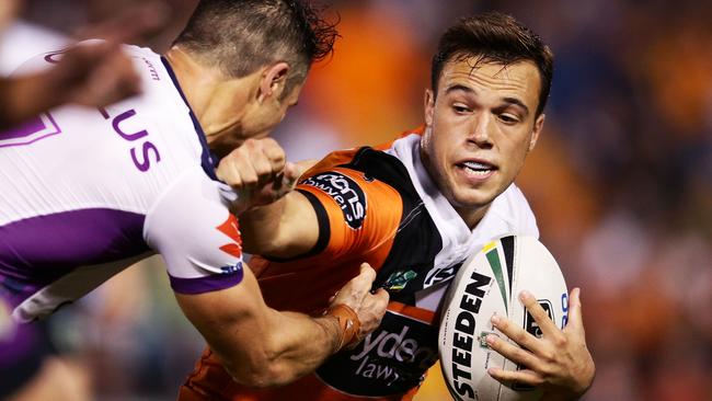 SYDNEY, AUSTRALIA - APRIL 17: Luke Brooks of the Tigers takes on the defence during the round seven NRL match between the Wests Tigers and the Melbourne Storm at Leichhardt Oval on April 17, 2016 in Sydney, Australia. (Photo by Matt King/Getty Images)