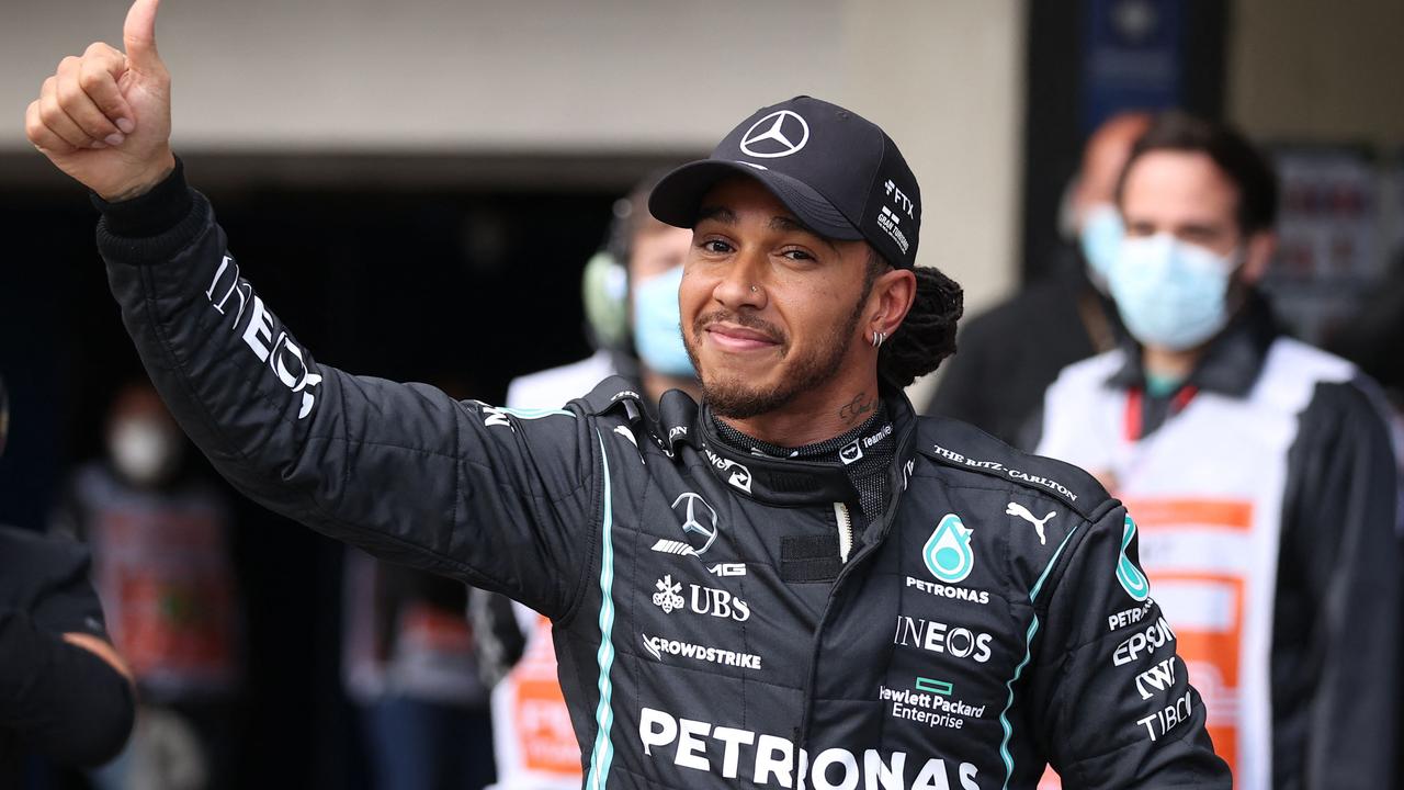 Mercedes' British driver Lewis Hamilton gives his thumb up. Photo by Lars BARON / POOL / AFP.