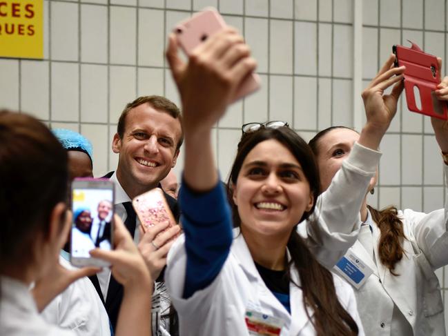 French President Emmanuel Macron (C) poses for a selfie with medical staff members as he visits the Robert Debre pediatric hospital in Paris on August 9, 2017. Picture: AFP PHOTO