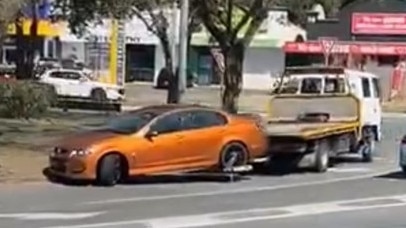 The Holden Commodore being taken away by a tow truck. Picture: Dennis Taunoa