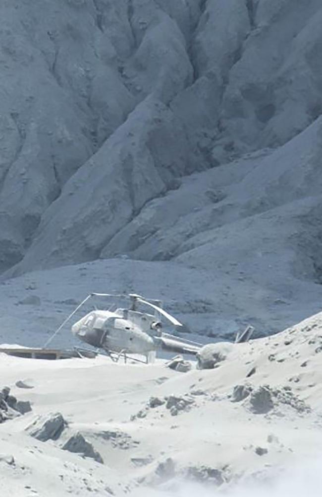 Wreckage of a helicopter amid ash minutes after the volcano on New Zealand's White Island erupted. Picture: AFP