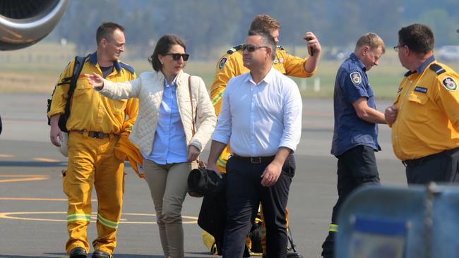 NSW Premier Gladys Berejiklian and Deputy Premier John Barilaro arriving at Port Macquarie airport with RFS volunteers. Picture: Nathan Edwards