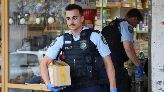 Police raid a store at Bankstown City Plaza. Picture: David Swift