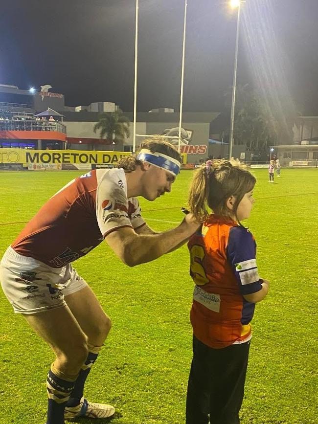 Liam Hampson signing a fans shirt after a rugby game with the Redcliffe Dolphins.