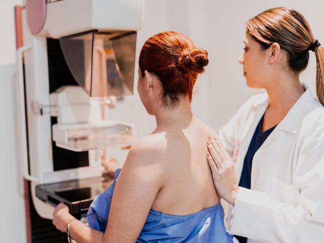 Doctor doing mammogram exam on patient at hospital