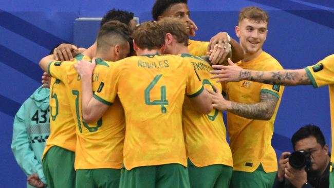 Australia's players celebrate their first goal during the Qatar 2023 AFC Asian Cup Group B football match between Australia and Uzbekistan at the Al-Janoub Stadium in Al-Wakrah, south of Doha on January 23, 2024. (Photo by Hector RETAMAL / AFP)