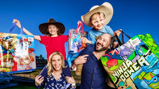 Ekka Tickets 2023.Tina and Tony White with their kids Lincoln, 4 and Felicity, 8 with showbags ahead of the Ekka.Picture: Nigel Hallett