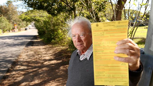 Dennis Culver, of Figtree Pocket, was fined for parking outside his home on an apparent footpath. Pic: Josh Woning.