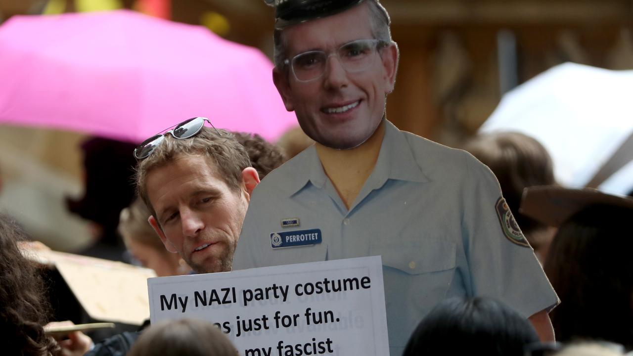 One protester held up a sign poking fun at NSW Premier Dominic Perrottet. Picture: NCA NewsWire / Damian Shaw