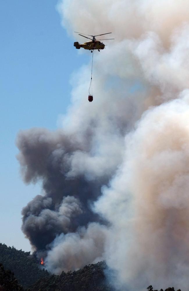 A firefighting helicopter flies above a forest fire near Mortagua, northern Portugal. Picture: AP