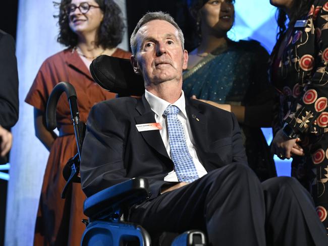 Daniher receiving his Australian of the Year honour. Gold said of Daniher: “I wrote asking if he would consider posing for a portrait. He kindly agreed to a 15-minute sitting at his home. In the end, I spent more than an hour with Neale and his wife Jan.” Photo: NewsWire / Martin Ollman