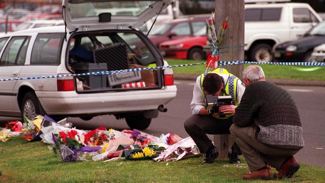 Forensic police check the murder site in Cochranes Rd.