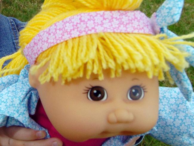 Seven year old Tess with assorted Cabbage Patch Kids dolls.