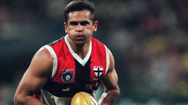 The great Nicky Winmar, pictured playing for St Kilda in the 1997 preliminary final, will be at Devon Meadows football club on Saturday.