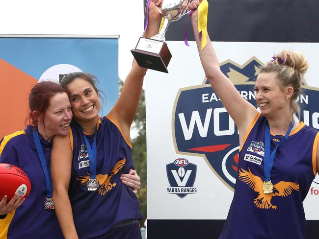 (L - R) Coach Meredith Denvir, Marissa Lee and Penelope Knight of Vermont celebrate with the trophy after ER Women's Footy (Div 1 GF): Mount Evelyn v Vermont on Sunday, September 9, 2018, in Lilydale, Victoria, Australia. Picture: Hamish Blair