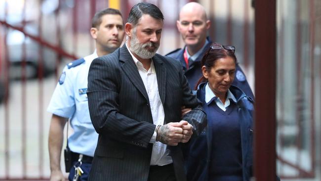 Karl Michael Hague is escorted from a prison van into the Supreme Court of Victoria in Melbourne, Friday, June 15, 2018. Picture: Image/David Crosling