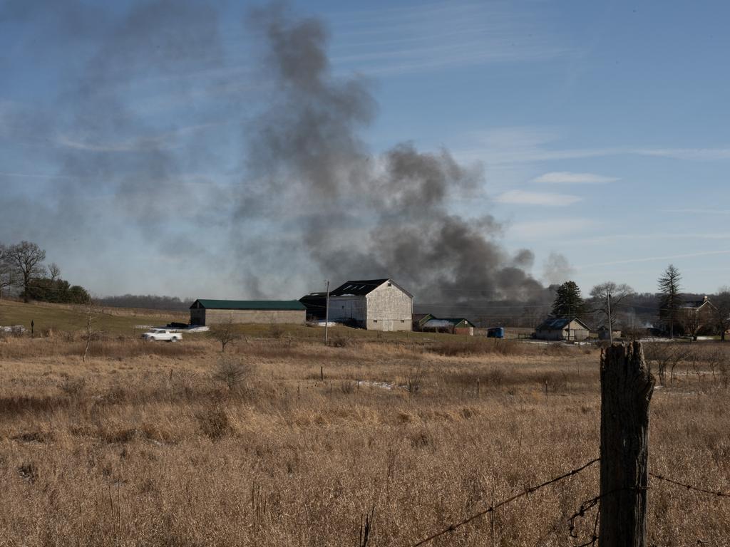 Odour and haze were reported over the area as the Norfolk Southern railway prepared further controlled releases of toxic vinyl chloride gas from several still-smouldering tanker cars.