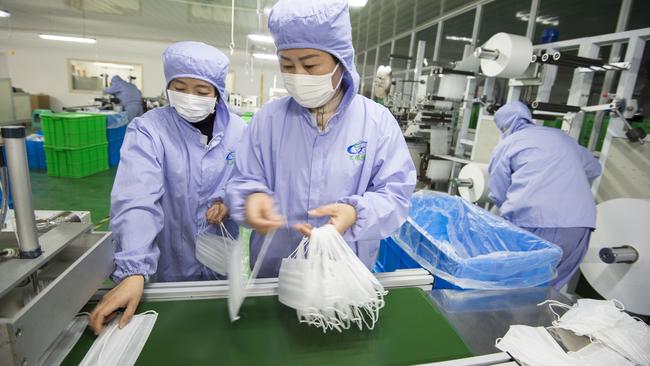 Workers on a production line at a factory for medical masks in Hai’an in eastern China’s Jiangsu Province on January 28. Picture: AP