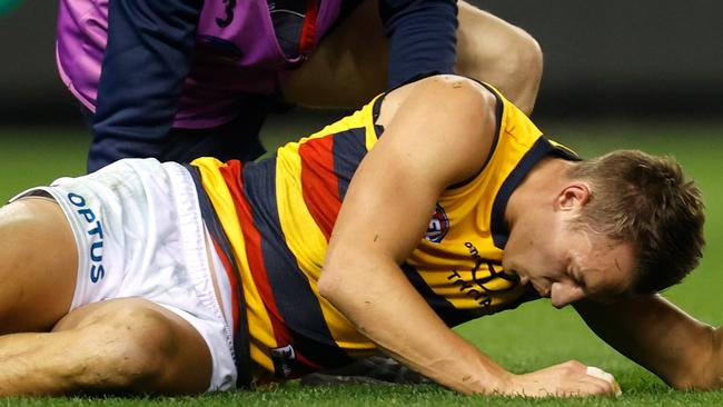 MELBOURNE, AUSTRALIA - JULY 09: Tom Doedee of the Crows lays injured during the 2021 AFL Round 17 match between the Essendon Bombers and the Adelaide Crows at Marvel Stadium on July 9, 2021 in Melbourne, Australia. (Photo by Michael Willson/AFL Photos via Getty Images)