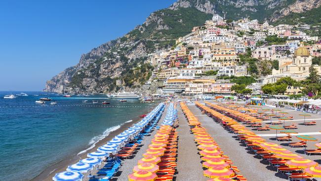 The blue and orange beach umbrellas of Positano Beach are as famous as the views. Picture: iStock