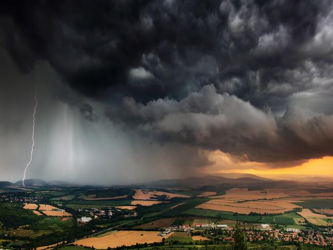 A severe thunderstorm shelf cloud races across the country side on a summer afternoon.