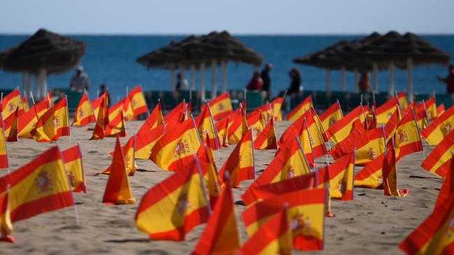 Thousands of Spanish flags, representing the Spanish victims of COVID-19, are pictured on Patacona beach in Valencia, on Sunday. Picture: AFP