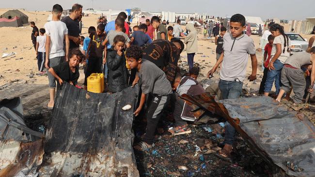 Palestinians gather at the site of an Israeli strike on a camp for internally displaced people in Rafah, amid ongoing battles between Israel and the Palestinian Hamas militant group.