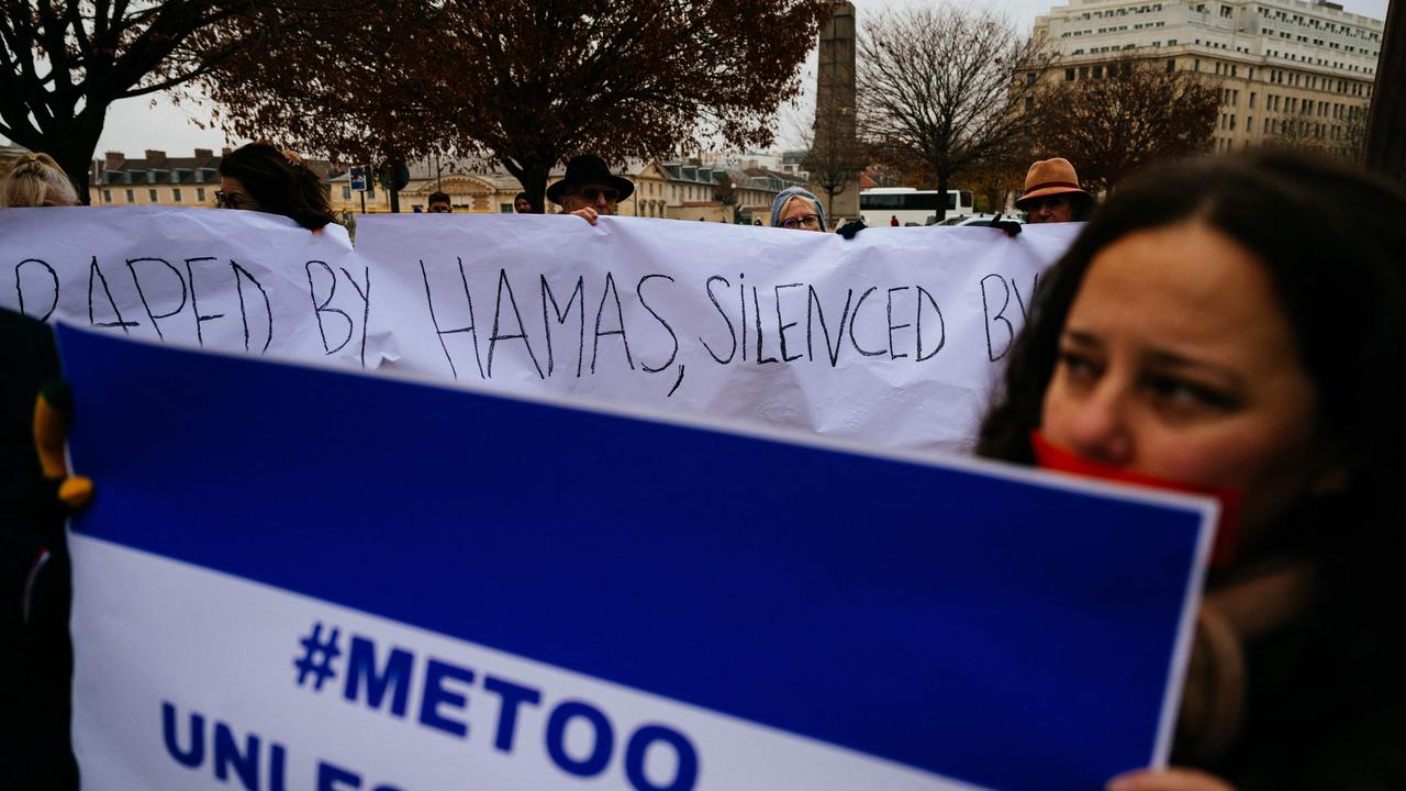 Demonstrators hold a banner and a placard during a rally organised by the Rape is Rape committee to "denounce the silence of international and feminist organisations" on rapes committed during the attack of October 7, 2023 on Israel, in front of UNESCO headquarters in Paris on December 1. Picture: AFP