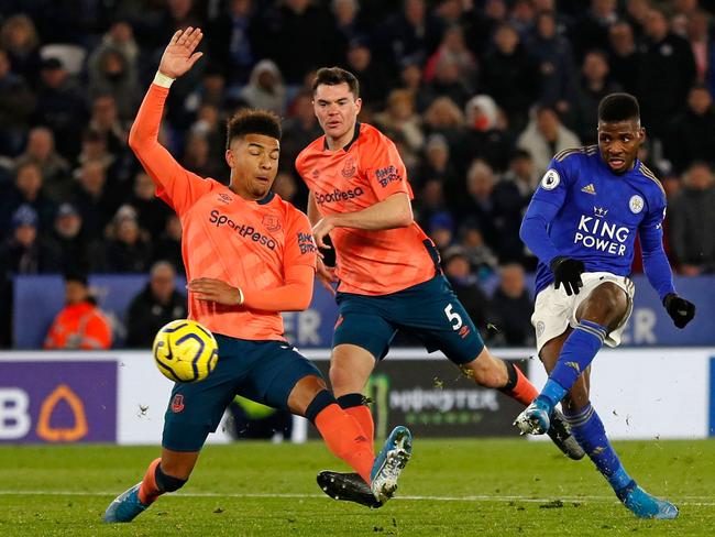 Leicester City's Nigerian striker Kelechi Iheanacho (R) shoots to score their late winning goal during the English Premier League football match between Leicester City and Everton at King Power Stadium in Leicester, central England on December 1, 2019. - Leicester won the game 2-1. (Photo by Adrian DENNIS / AFP) / RESTRICTED TO EDITORIAL USE. No use with unauthorized audio, video, data, fixture lists, club/league logos or 'live' services. Online in-match use limited to 120 images. An additional 40 images may be used in extra time. No video emulation. Social media in-match use limited to 120 images. An additional 40 images may be used in extra time. No use in betting publications, games or single club/league/player publications. /