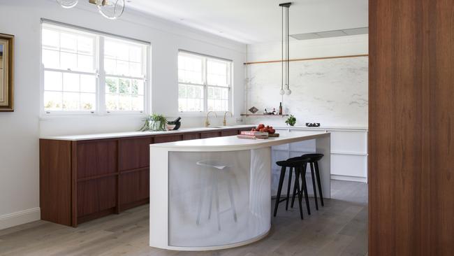 A curved entry to this kitchen by Mimosa makes for an easier flow in a busy workspace.