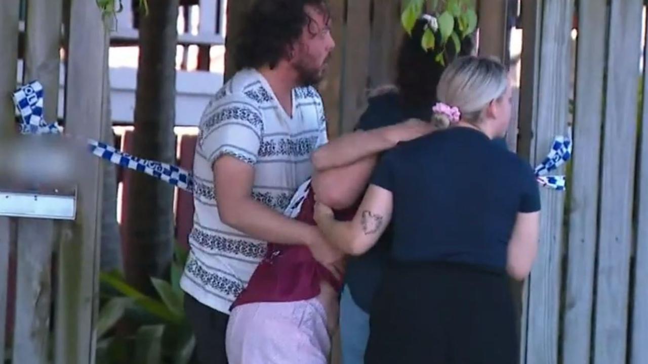 Loved ones grieving the 29-year-old man outside the home on Sunday. Picture: Nine