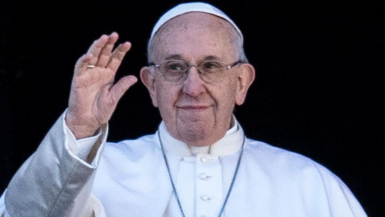 Pope Francis waves from the balcony of St Peter's basilica during the traditional "Urbi et Orbi" Christmas message to the world. Picture: AFP