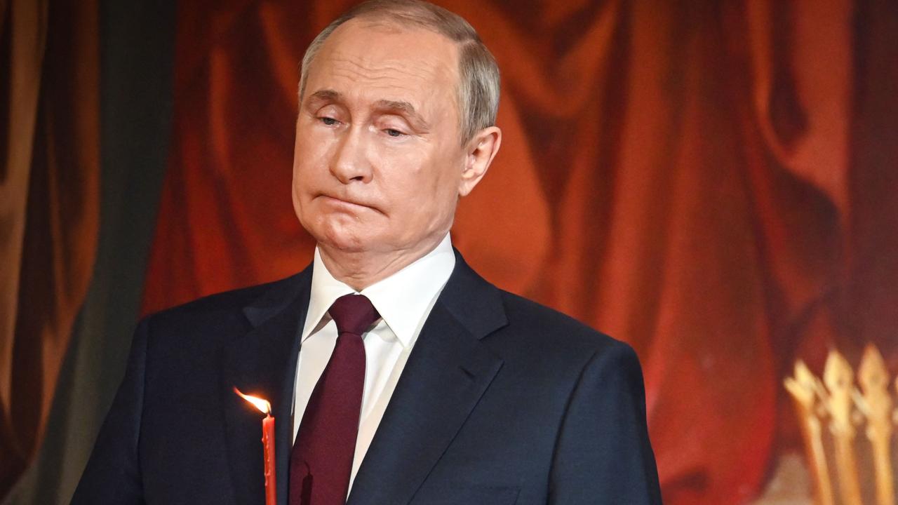 Vladimir Putin was seen biting his lips at midnight mass in Moscow. Picture: AFP