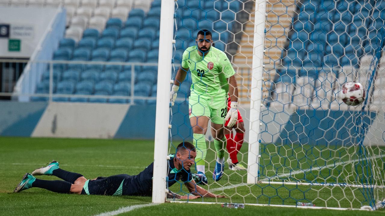 Mitch Duke heads home the Socceroos’ second goal against Bahrain. Picture: Martin Dokoupil/Getty Images