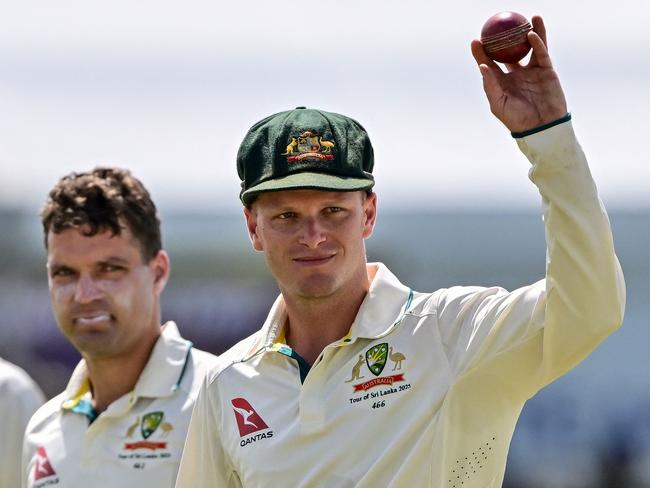 TOPSHOT - Australia's Matthew Kuhnemann (R) celebrates after taking a five-wicket haul as he walks back to the pavilion at the end of Sri Lanka's second innings during the fourth day of the first Test cricket match between Sri Lanka and Australia at the Galle International Cricket Stadium in Galle on February 1, 2025. (Photo by Ishara S. KODIKARA / AFP)