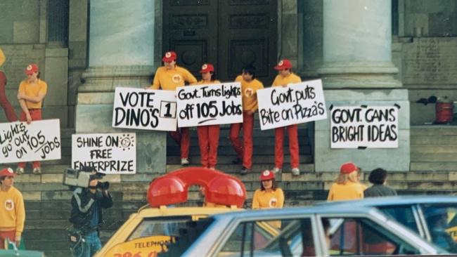 Dial-a-Dino's staff protesting out the front of the SA parliament in 1985 after the Government told them to turn off the lights in the phone receivers on top of their delivery cars because they could be confused with emergency vehicles. Photo: Richard Wescombe