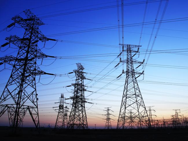 The silhouette of the evening electricity transmission pylon