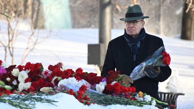 French Ambassador to Russia Pierre Levy lays flowers for late Russian opposition leader Alexei Navalny at the Solovetsky Stone, a monument to political repression that has become one of the sites of tributes for Navalny, in Moscow on Monday. Picture: AFP