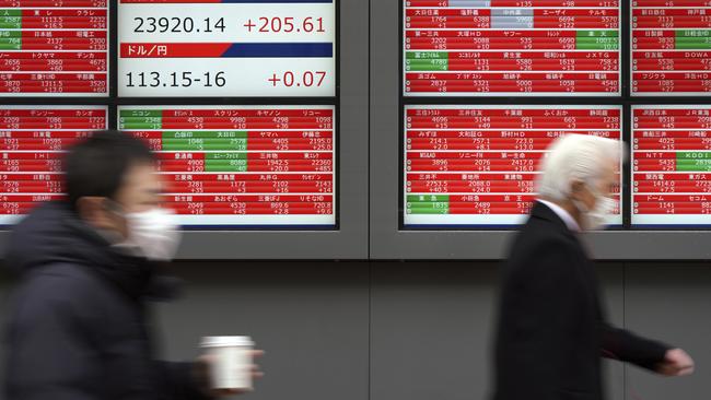 Men walk past an electronic stock board showing Japan's Nikkei 225 index at a securities firm in Tokyo Tuesday, Jan. 9, 2018. Asian shares rose Tuesday, cheered by the upbeat mood on Wall Street and hopes for U.S. economic growth. (AP Photo/Eugene Hoshiko)