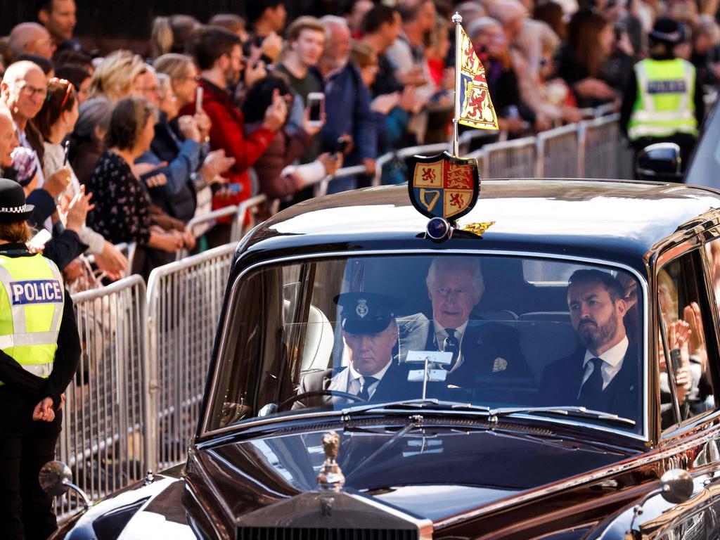 King Charles III and Britain's Camilla, Queen Consort (unseen) are driven along the Royal Mile towards the Palace of Holyroodhouse, in Edinburgh. Picture: AFP