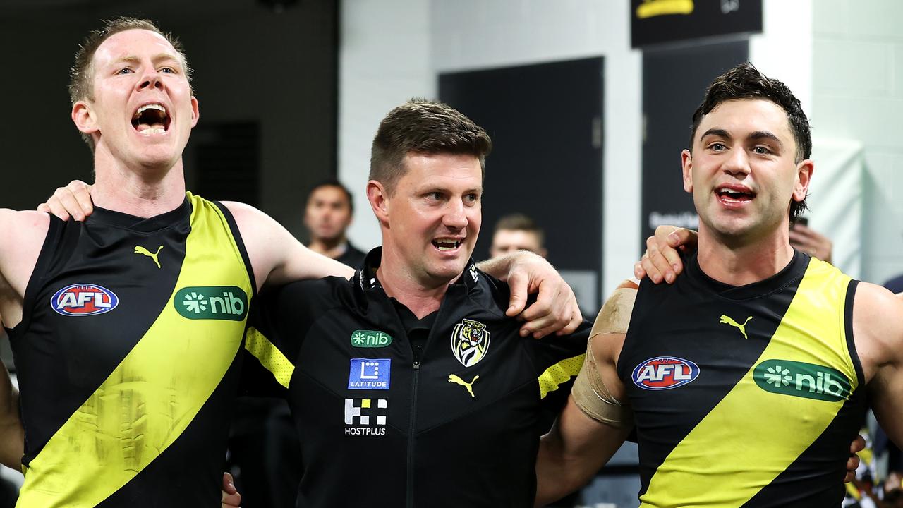 Jack Riewoldt, Tigers interim head coach Andrew McQualter and Tim Taranto sing the team song. Picture: Mark Kolbe