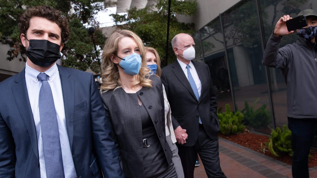 Ms Holmes leaving the courthouse with her partner, Billy Evans, and her parents. Picture: Nick Otto / AFP.