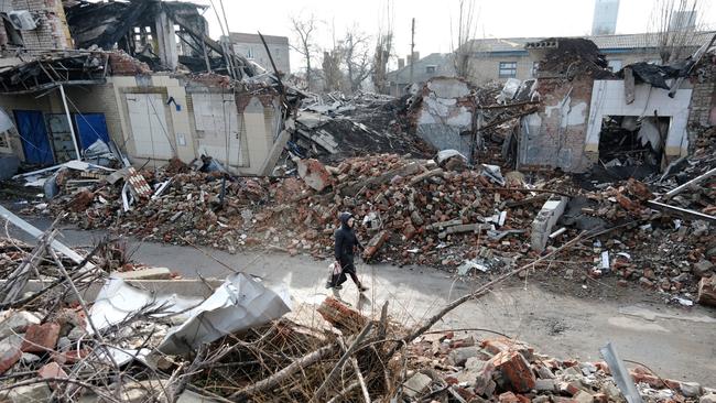 A woman walks by destroyed buildings in the Ukrainian mining town of Toretsk, which is situated less than 30km from the front lines of fighting. Picture: Spencer Platt/Getty Images