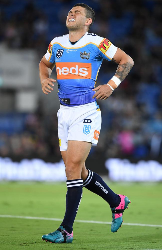 Ashley Taylor grimaces as he tries to fight through his injury. Picture: AAP Image/Dave Hunt