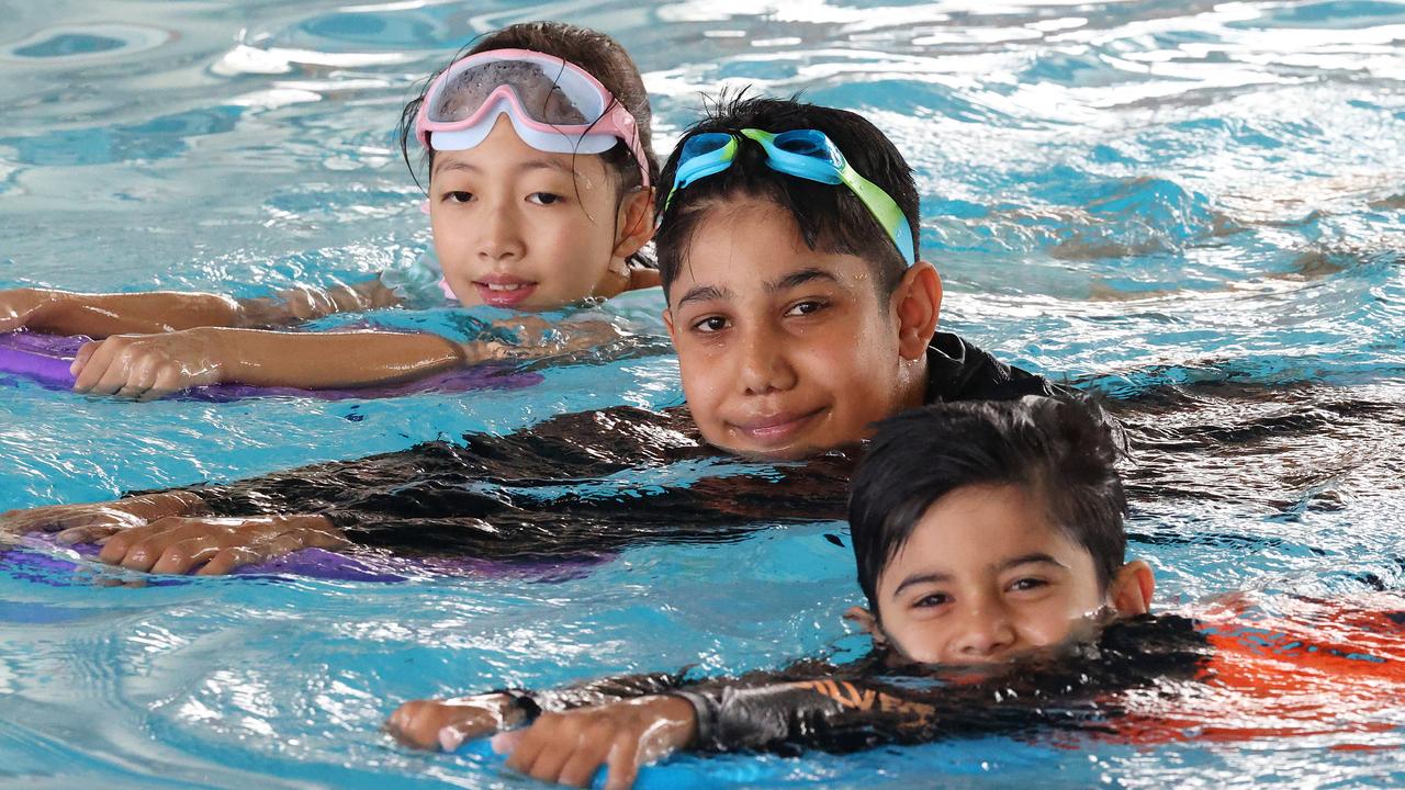 Chloe Zhu, 9, Moosa Muhammad, 12, and Eesa Muhammad, 6, learning to swim at Mt Gravatt East. Picture: Liam Kidston